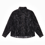Sheer black wavy velvet patterned shirt on a white background