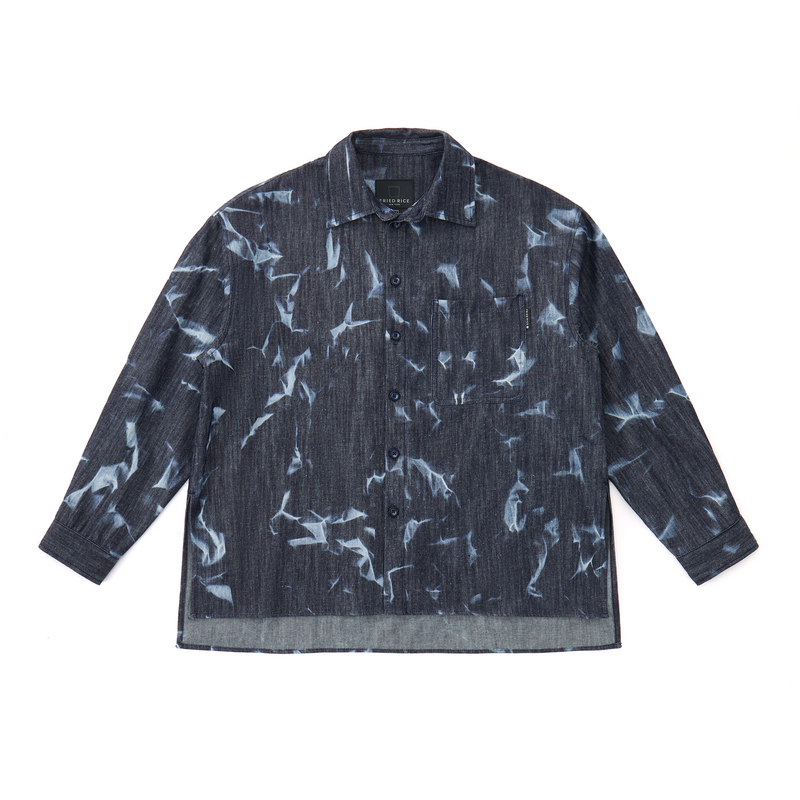 Dark denim shirt with abstract bleached pattern on a white background