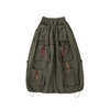 Green skirt with multiple pockets and colorful drawstrings on a white background