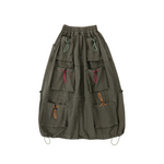 Green skirt with multiple pockets and colorful drawstrings on a white background