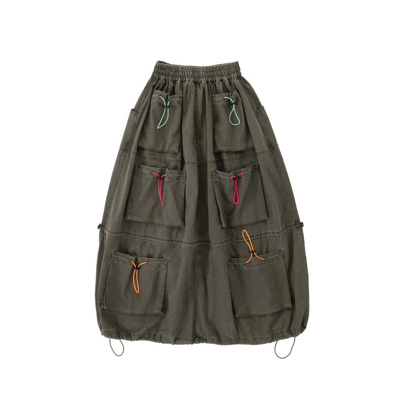 Green skirt with multiple pockets and colorful drawstrings on a white background