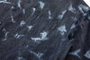 Close-up of a dark denim shirt with side pocket