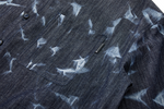 Close-up of a dark denim shirt with side pocket