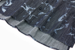 Close-up of a dark denim blue shirt with white abstract patterns hem