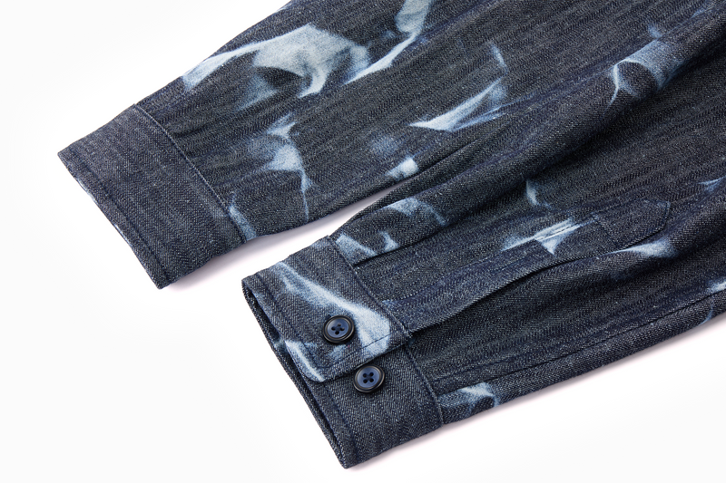Close-up of a long-sleeved dark denim blue shirt with cuff sleeves 