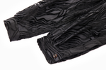 Black textured fabric with pleated cuff design on a white background
