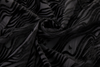 Close-up of black textured fabric with wavy pattern