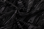 Close-up of black textured fabric with wavy pattern