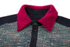 Close-up of a dark patterned shirt with a bright magenta collar on a white background