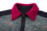 Close-up of a dark patterned shirt with a bright magenta collar on a white background