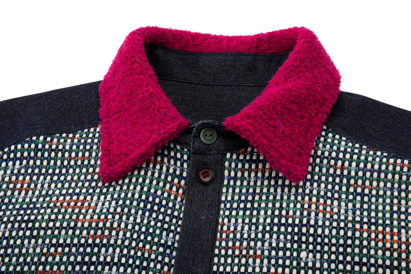 Close-up of a dark patterned shirt with a bright magenta collar on a white background
