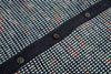 Close-up of a textured fabric with buttons and a checkered pattern