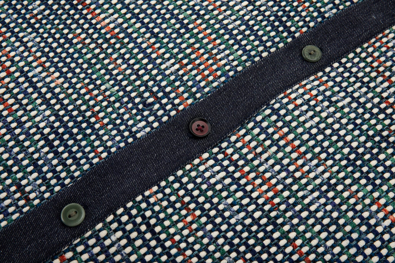 Close-up of a textured fabric with buttons and a checkered pattern