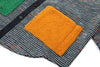 Textured fabric with a mustard yellow square patch on a multicolored background