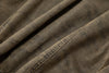 Close-up of brown fabric with suede brown camo wash